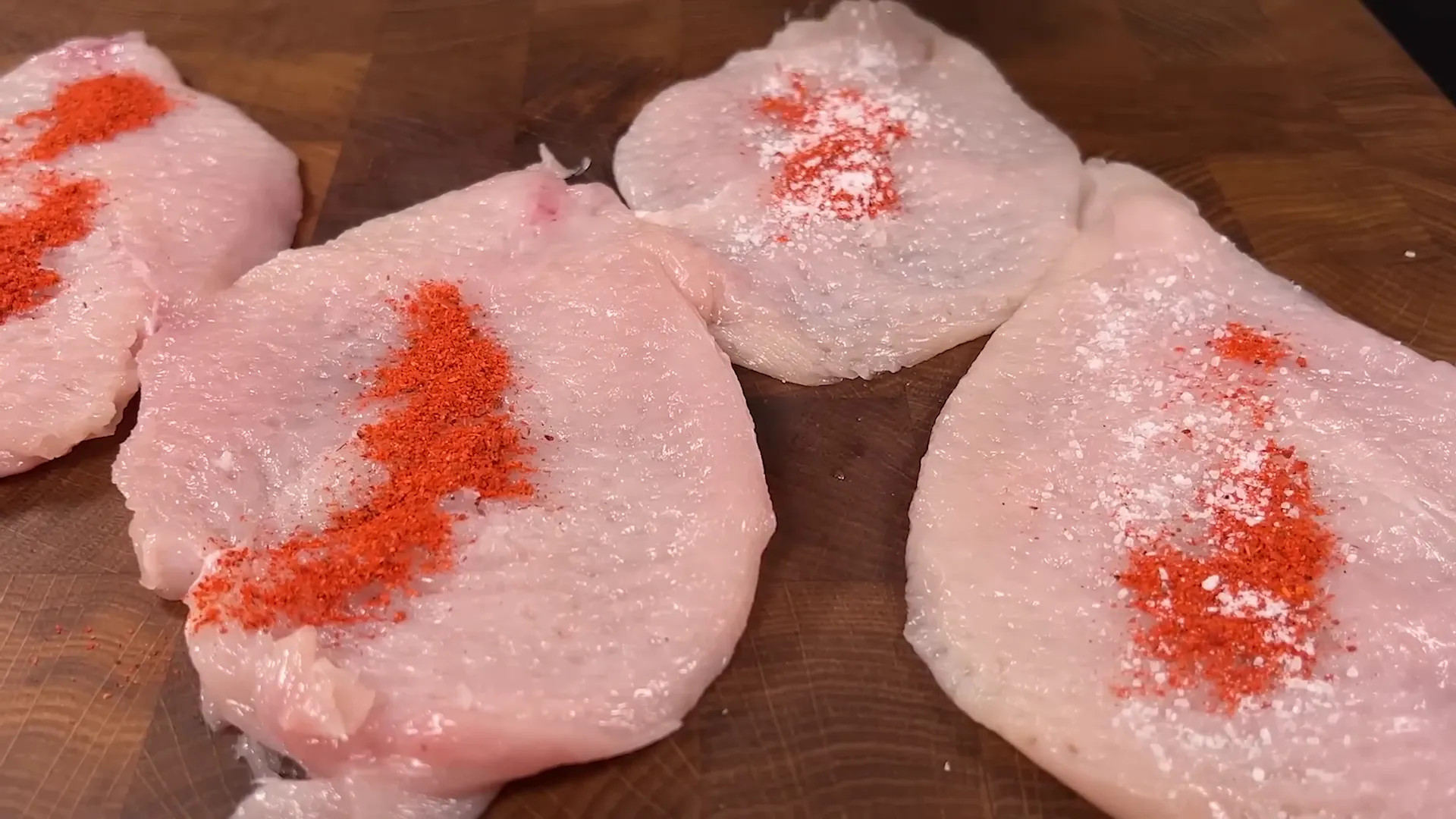 Seasoning chicken fillets with paprika