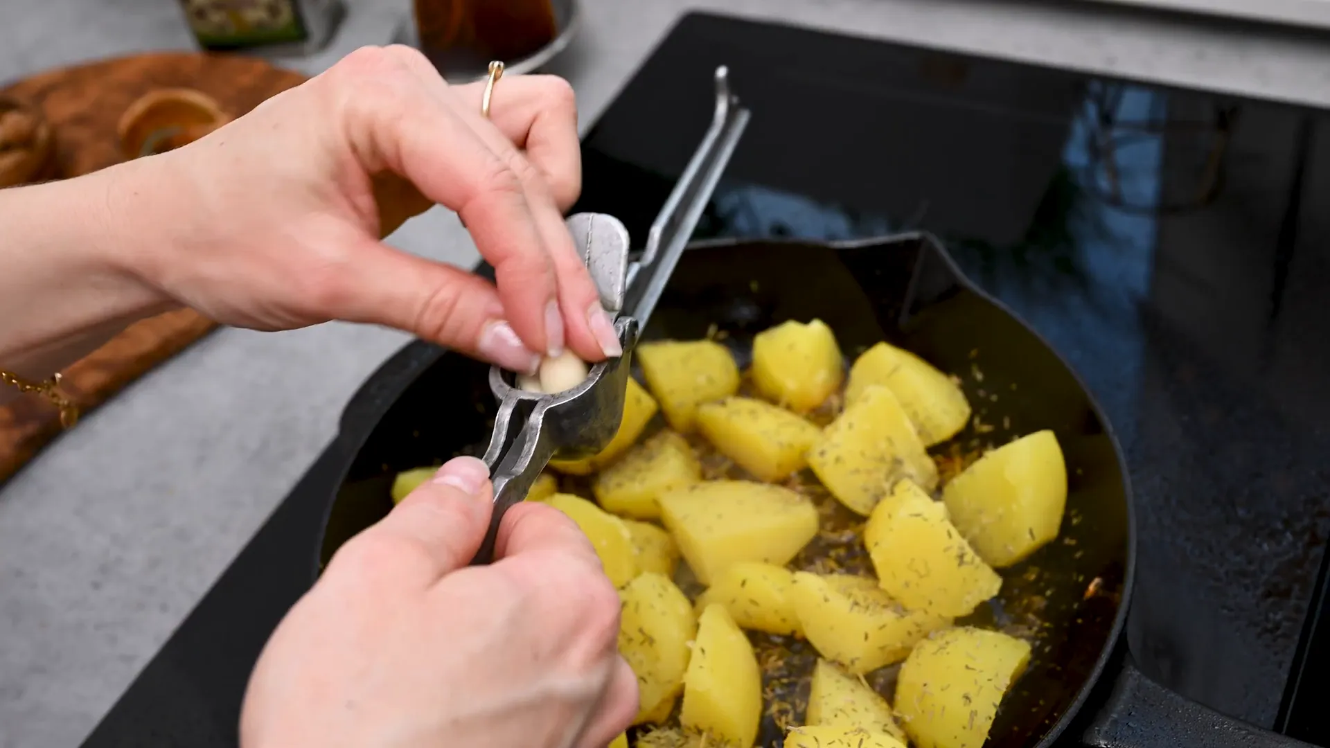 Adding thyme and rosemary to frying potatoes