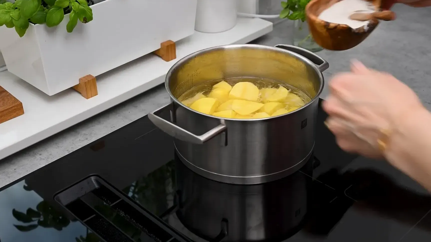 Boiling potato cubes in salted water