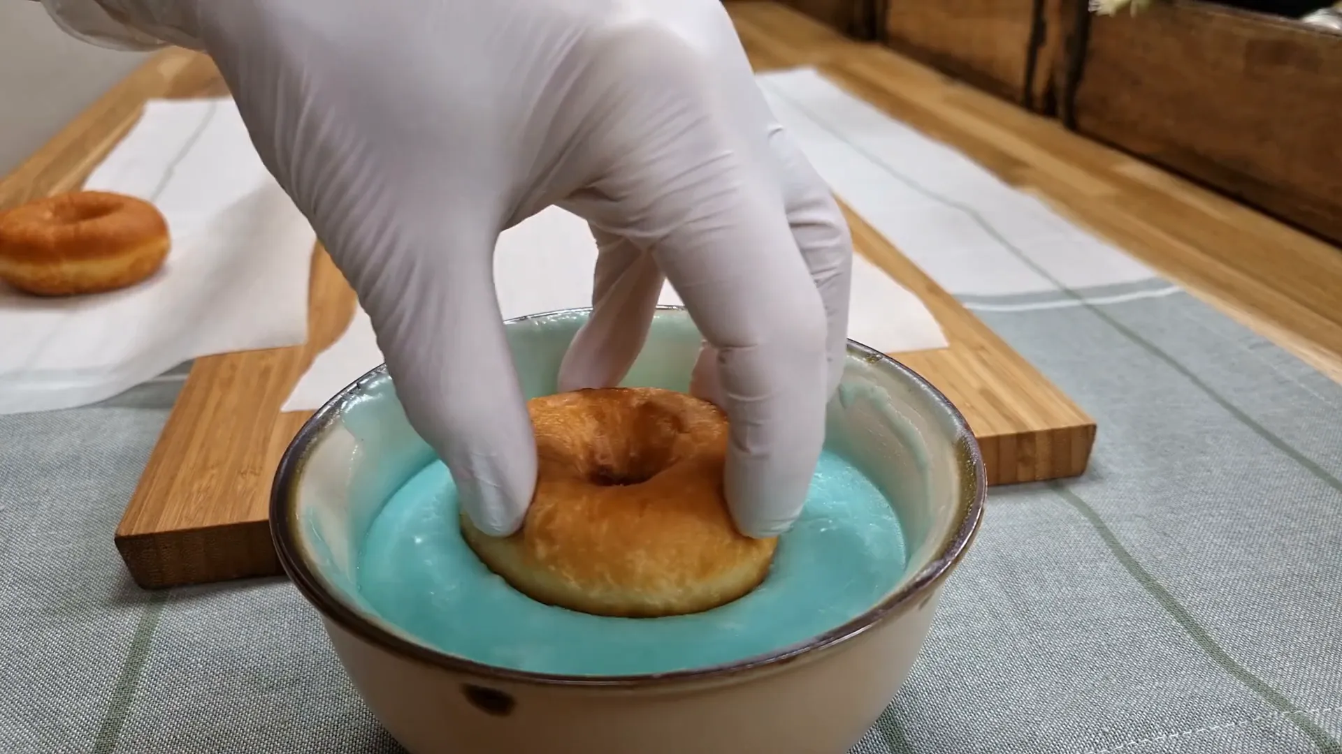 Dipping donuts into glaze